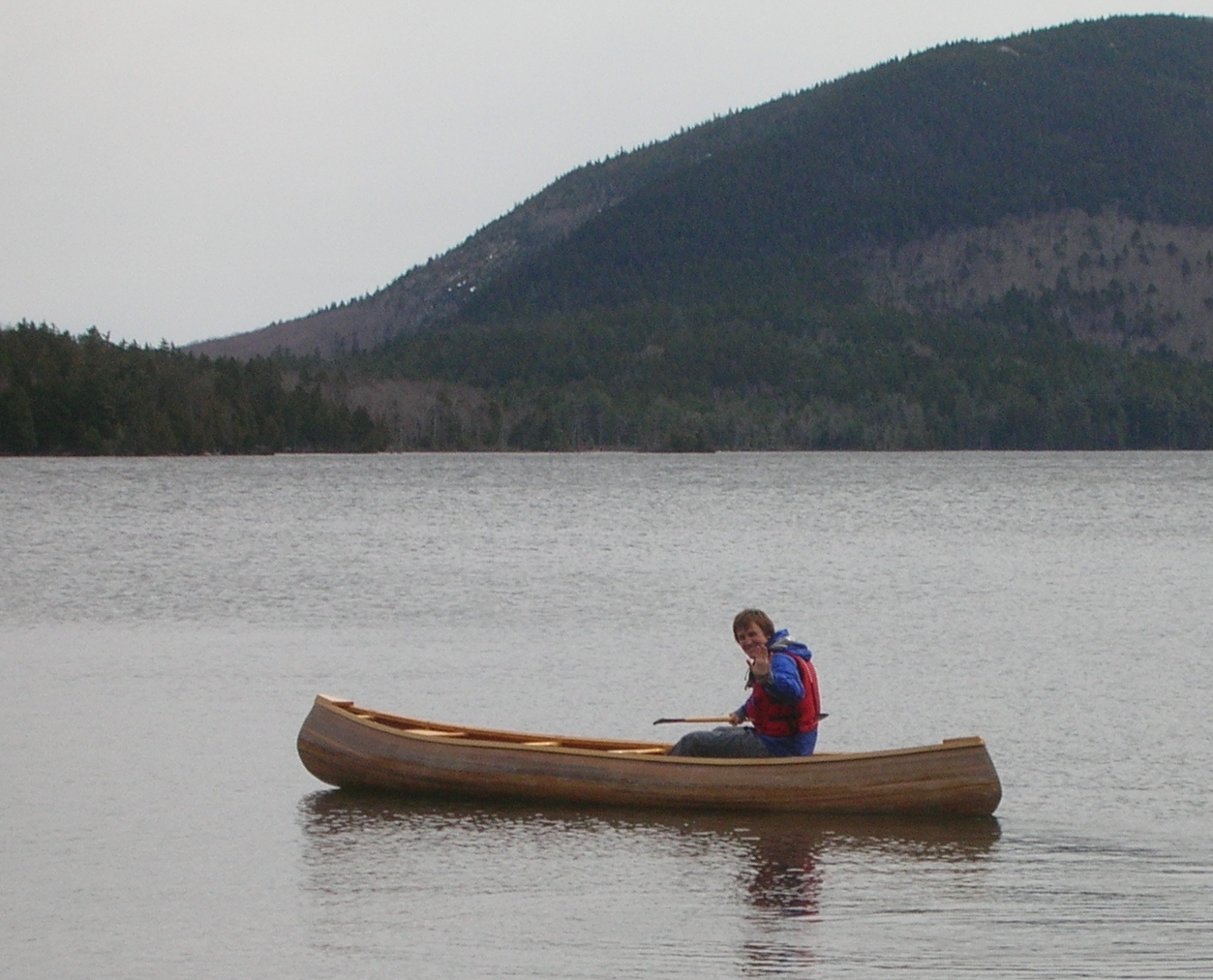 Noah paddles the canoe he built